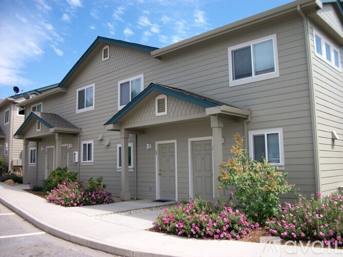 A row of houses with a clear blue sky above them.