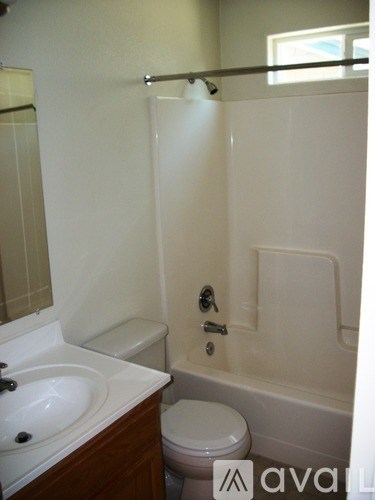 A white bathroom with a toilet and sink.