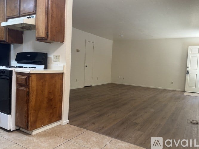 A kitchen with wooden cabinets and a black printer on the counter.