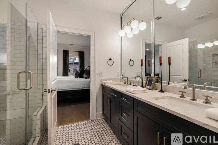 A bathroom with a mirror, sink, and a shower.