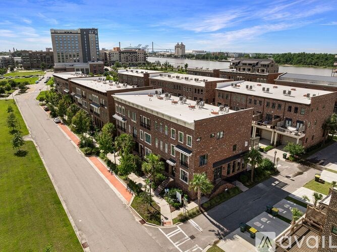 A large brick building with a parking lot in front.