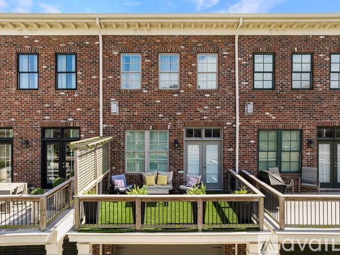 A brick building with a balcony in front.