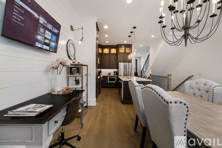 A modern home office with a large desk and comfortable seating area.