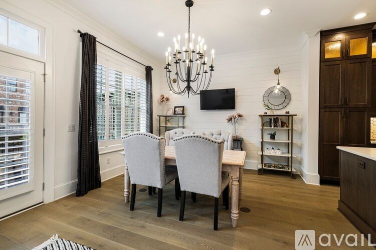A dining room with a wooden table and chairs.