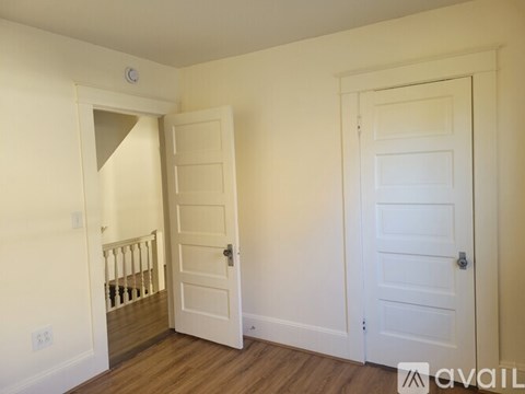 A room with two doors and a staircase.