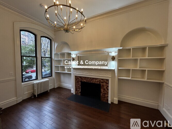 A room with a fireplace and a chandelier.