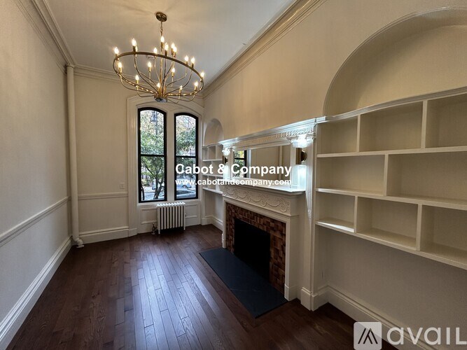 A room with a fireplace and a chandelier.