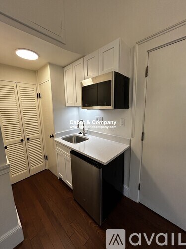 A kitchen with a sink and a microwave.