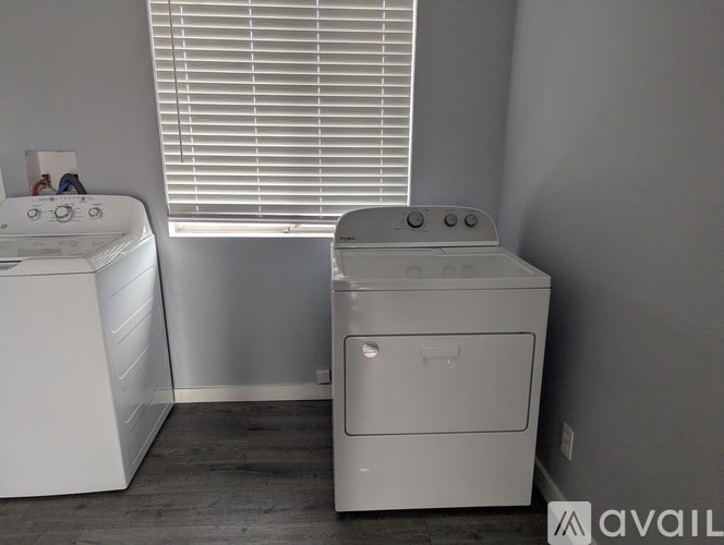 A white washing machine and dryer in a laundry room.