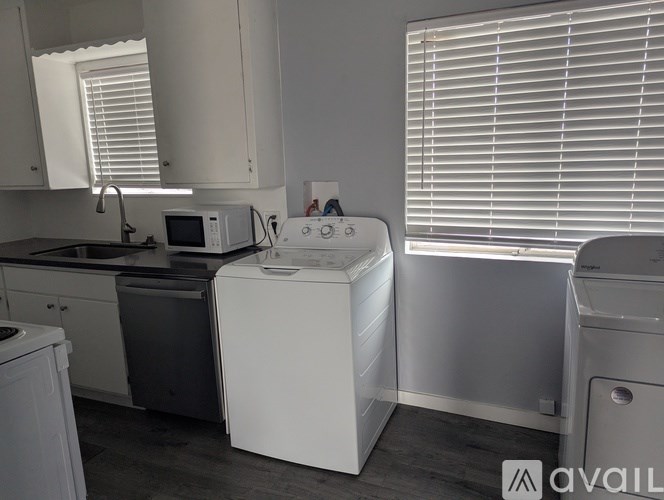 A white washing machine in a kitchen.