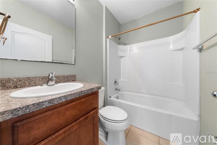 A bathroom with a white toilet, a sink, and a bathtub.