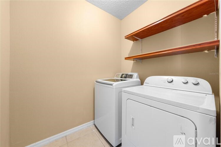 A small laundry room with a washer and dryer.