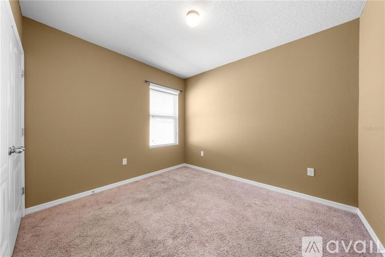 A room with beige walls and a carpeted floor.