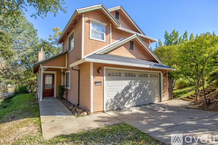 A two-story house with a garage is for sale.