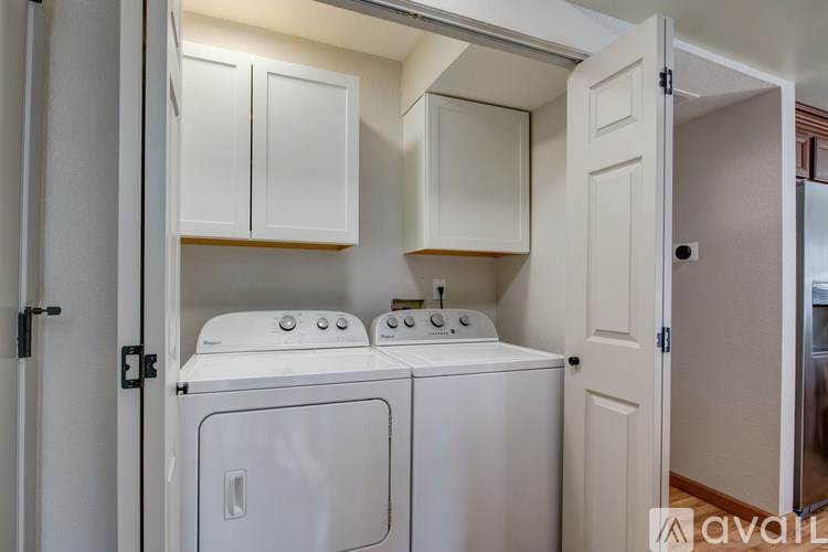 A small laundry room with a washer and dryer.