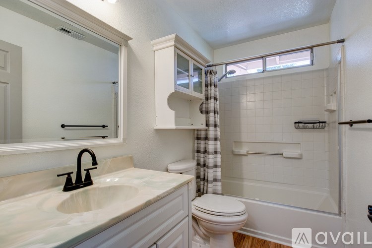 A bathroom with a sink, toilet, and bathtub.