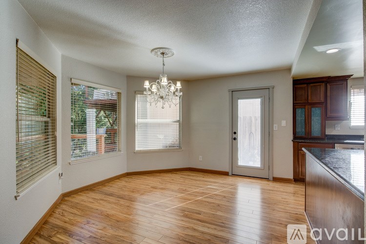 A room with wooden floors and a chandelier.