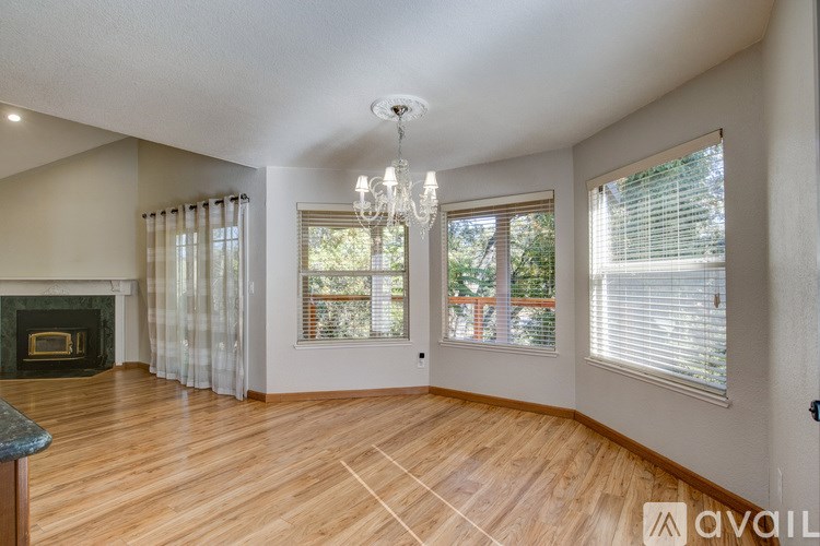 A room with a fireplace and a chandelier.
