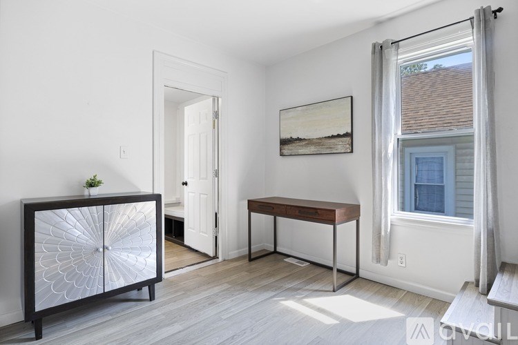 A room with a white wall and a white door.