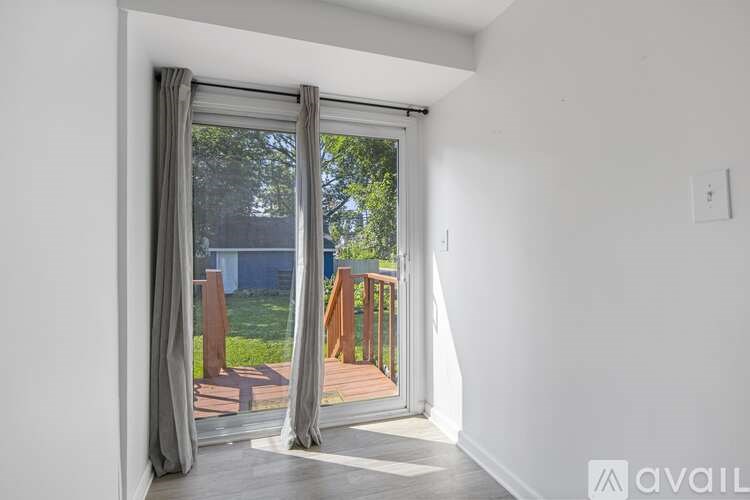 A room with a sliding door leading to a balcony.