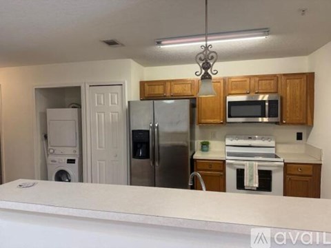 A kitchen with wooden cabinets and stainless steel appliances.