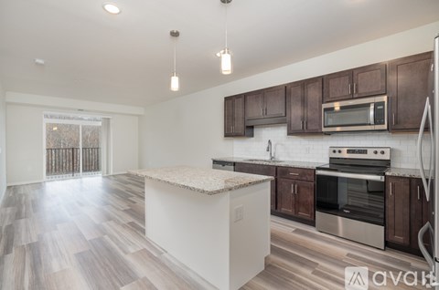 A kitchen with brown cabinets and a white island.