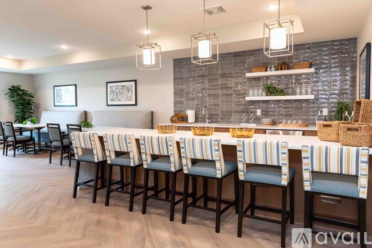 A bar area with striped bar stools and a counter.