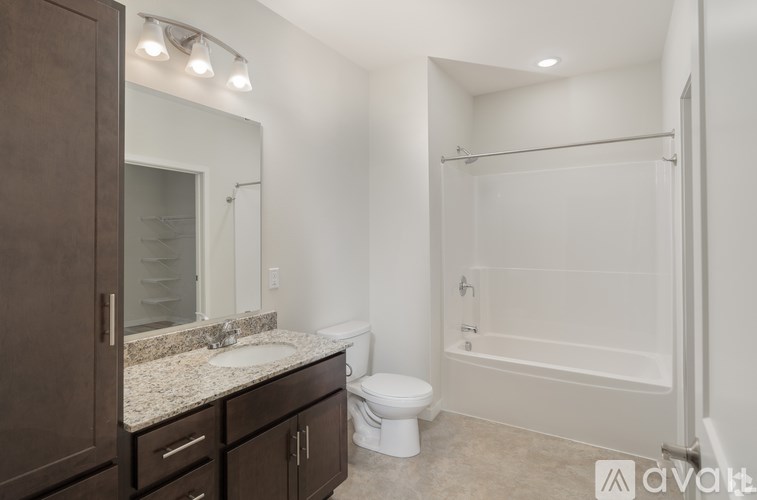 A bathroom with a toilet, sink, and shower.