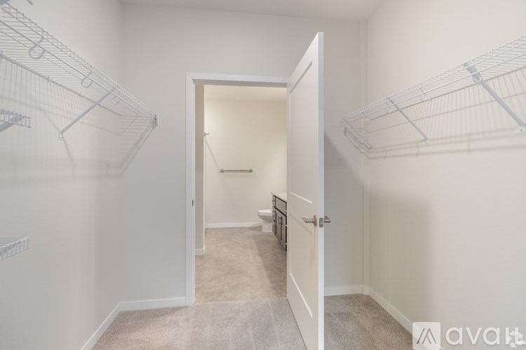 A white room with a white door and a white wall.