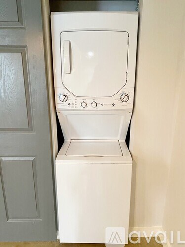 A white washing machine in a laundry room.
