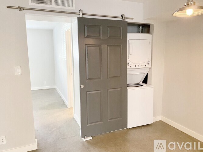 A room with a grey door and a white cabinet.