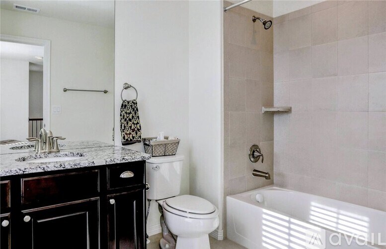 A bathroom with a toilet, sink, and bathtub.