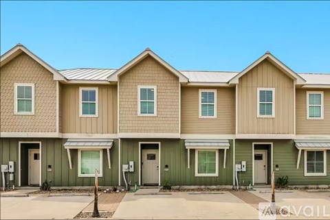 A row of houses with a clear blue sky above them.