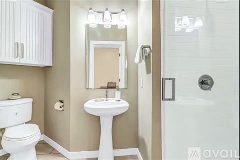 A white sink and toilet in a bathroom.