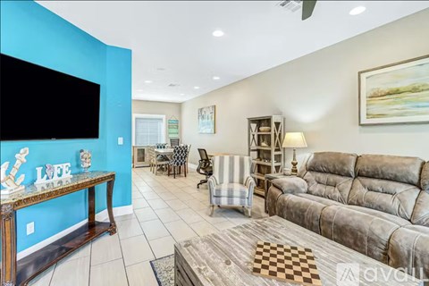 A living room with a television, sofas, and a coffee table.
