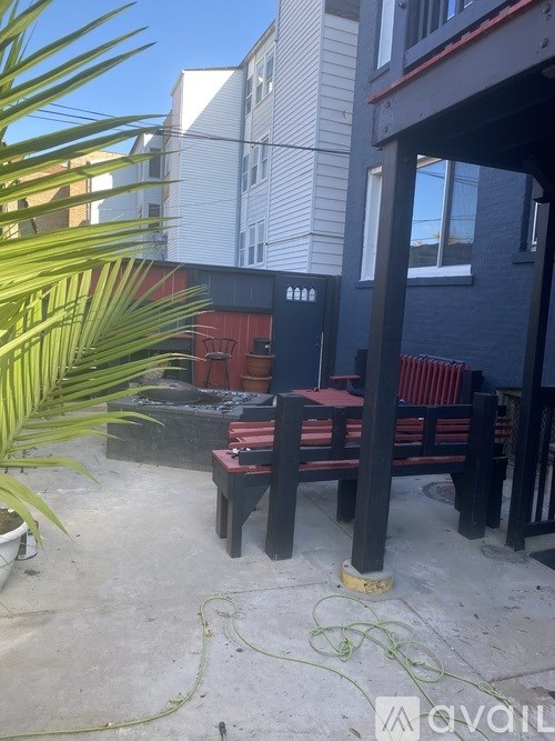A patio with a table and chairs is in front of a building.