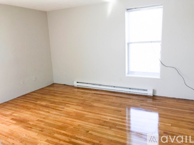 Empty room with wooden floor and window.