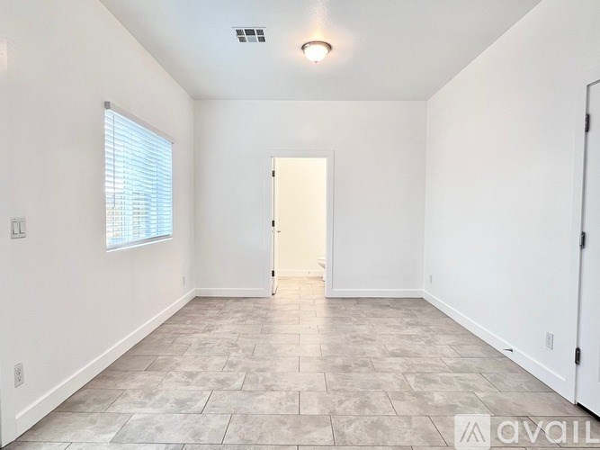 A room with a tiled floor and a door in the middle.