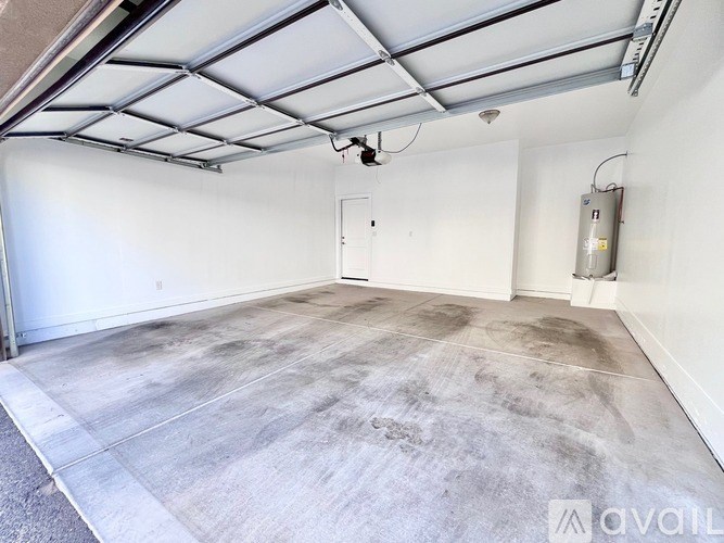 A spacious room with a concrete floor and a ceiling with exposed ductwork.