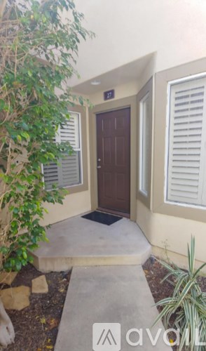 A brown door is closed with a mat in front of it.