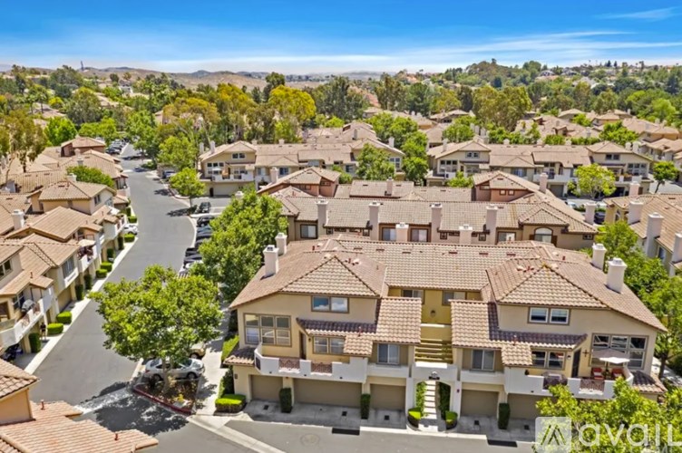 A residential area with houses and a clear sky.