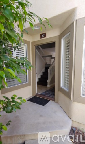 A small white door with a glass window is open.