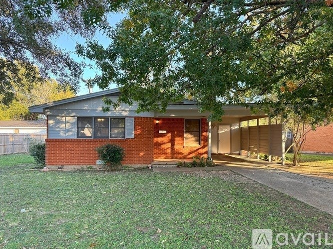 A house with a red brick exterior is available for rent.