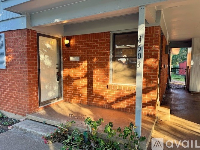 A brick house with a number 4503 on the window.