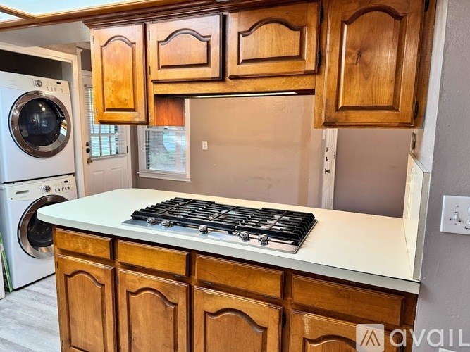 A kitchen with wooden cabinets and a white countertop.