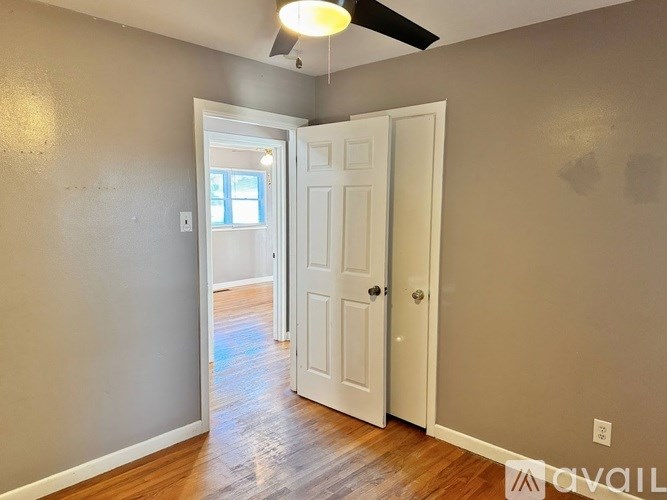 A room with a white door and a window.