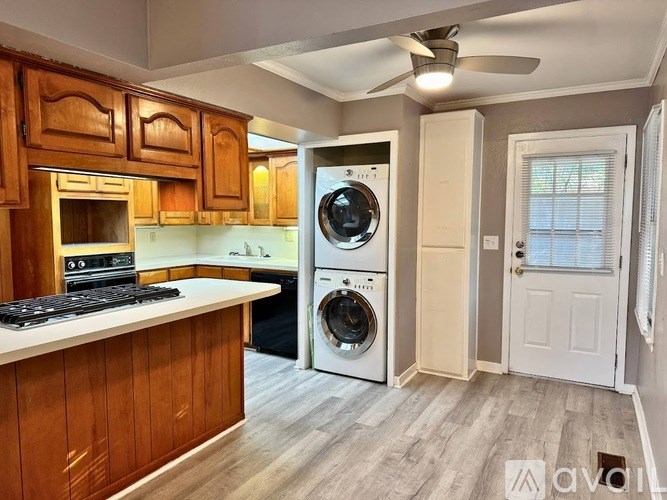 A kitchen with wooden cabinets and a white countertop.