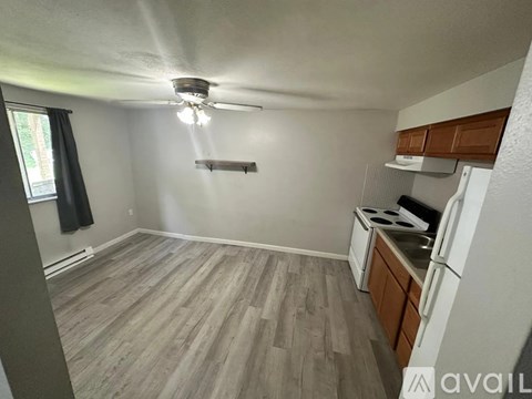 A kitchen with a refrigerator, stove, and oven.