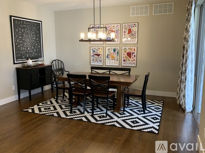 A dining room with a wooden table and chairs.