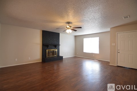 A room with a fireplace and a ceiling fan.